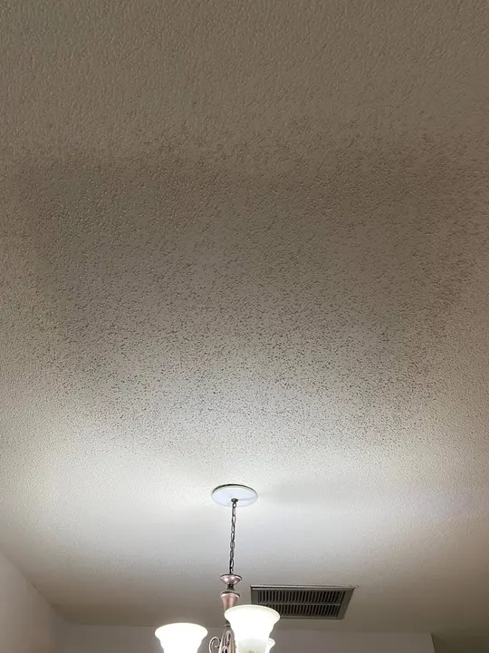 Same ceiling patched with the texture matched — no visible repair