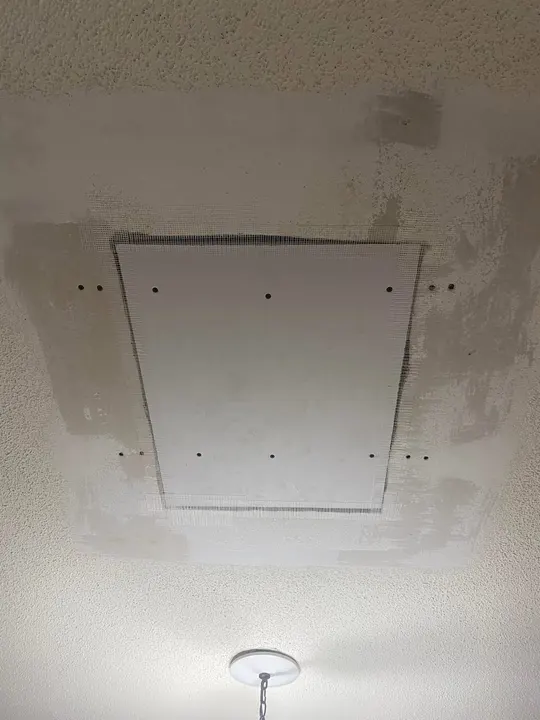 Ceiling patch installed with mesh tape before texture matching