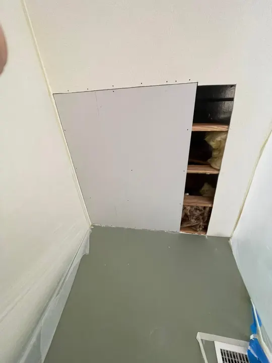 Closet wall with new drywall replacing a damaged section