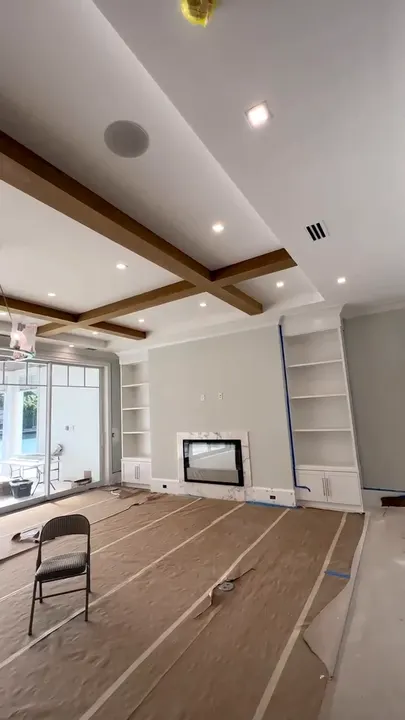 Great room with coffered beam ceiling and smooth drywall walls