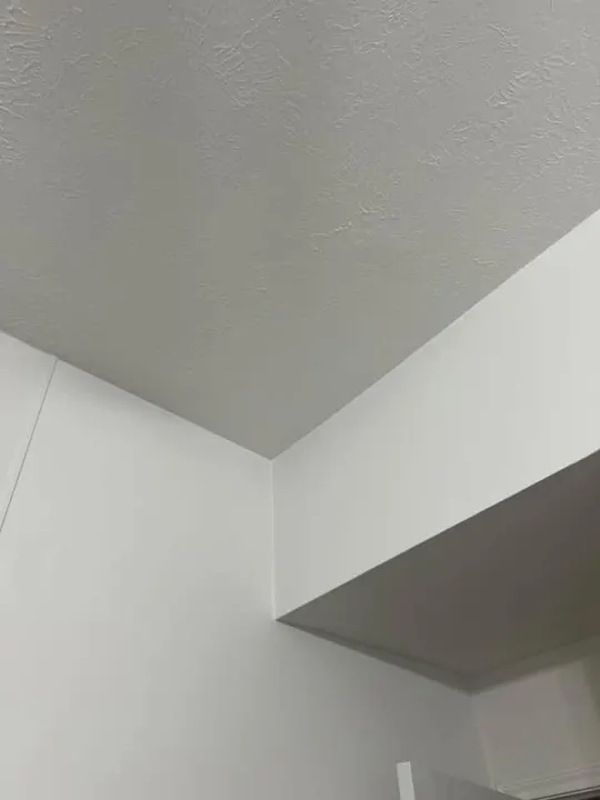 Smooth-finished ceiling and bulkhead corner ready for paint