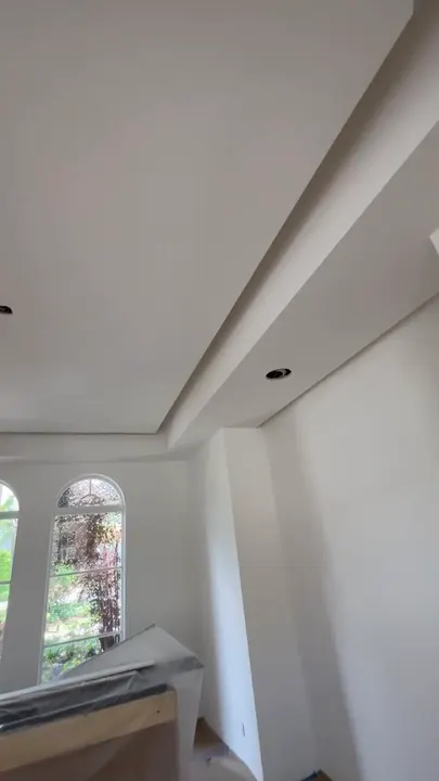 Tray ceiling and arched windows finished in smooth drywall