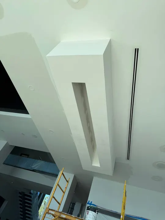 Two-story drywall soffit with linear slot detail and crisp corners